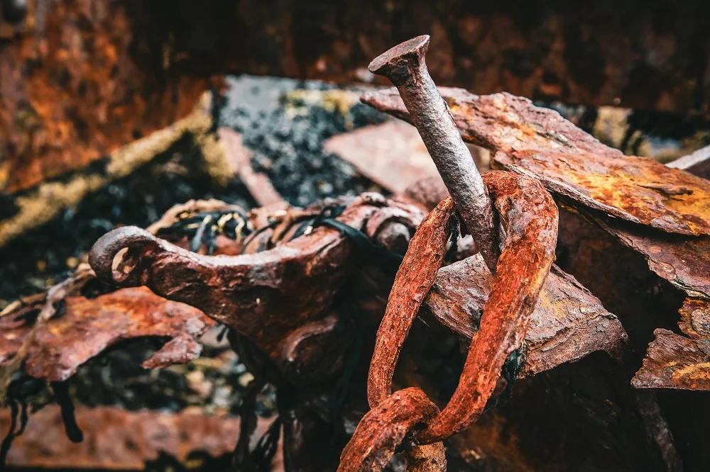 closeup shot of a nail with a rusty chain hanging 2026 01 07 23 10 57 utc