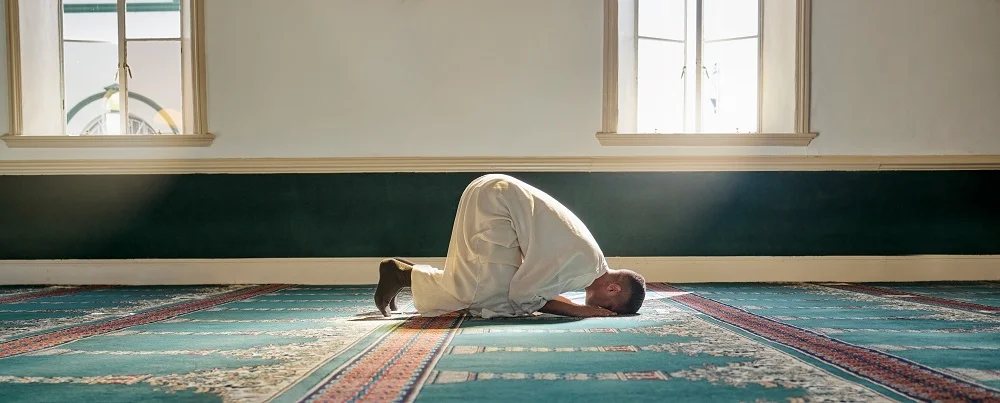 mosque worship and muslim man in prayer on his kn 2026 01 09 09 39 06 utc
