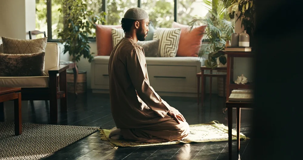 muslim man and kneeling in prayer at house for sp 2026 01 09 10 46 57 utc