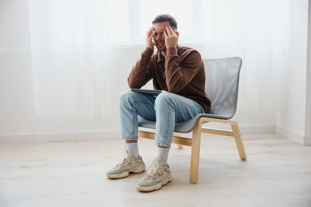 tormented upset crying young man feels pain in bac 2026 01 09 00 16 47 utc