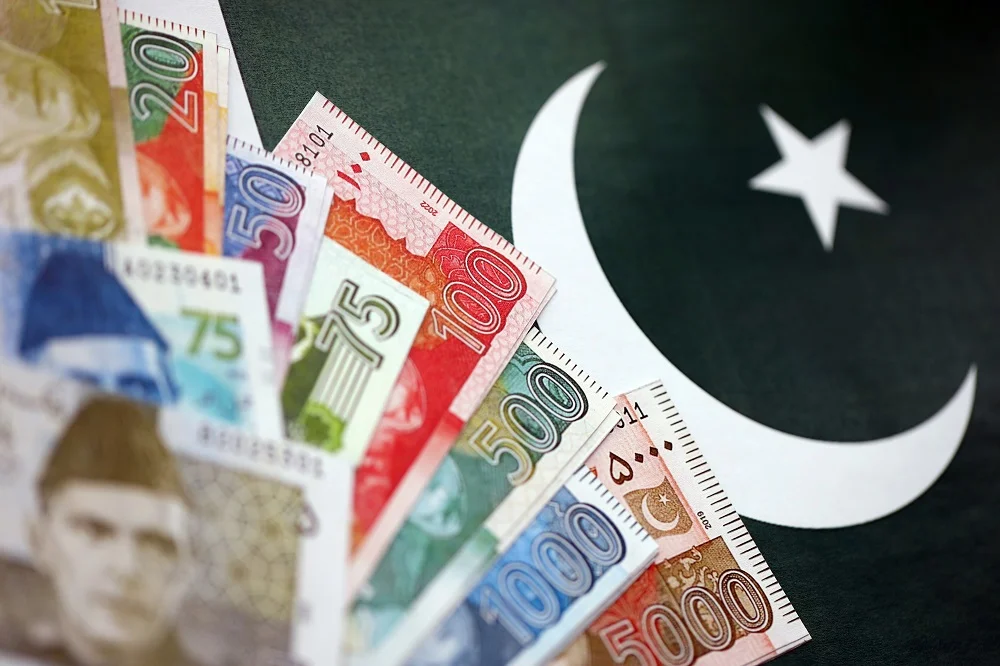 pakistan rupees banknotes on pakistani flag backgr 2026 03 25 04 18 38 utc