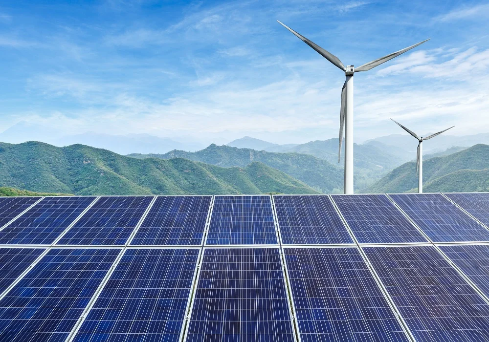 solar panels and wind turbines with mountains land 2026 03 26 06 22 01 utc