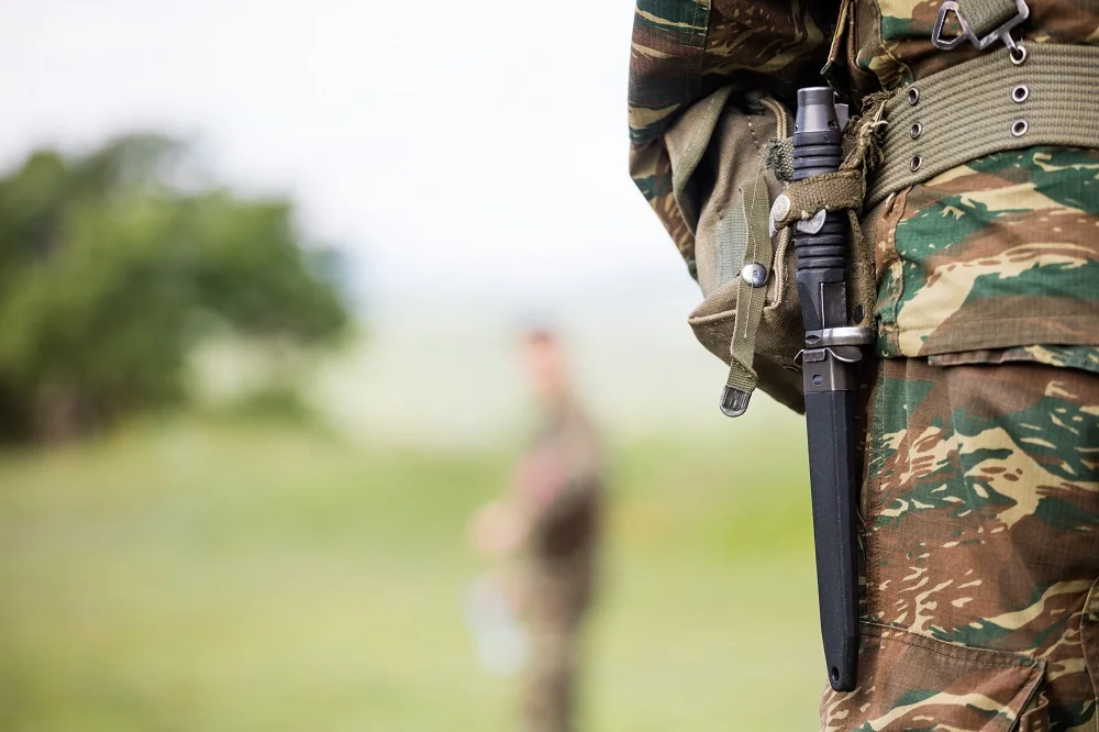 camouflage uniform and military knife in field 2026 03 17 14 26 27 utc
