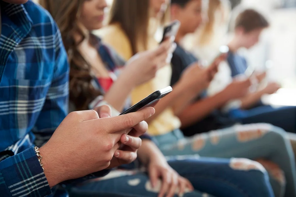 close up of a line of high school students using m 2026 01 05 06 27 04 utc
