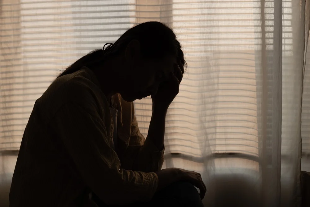 female having depression sitting alone in bedroom 2026 01 08 06 38 07 utc