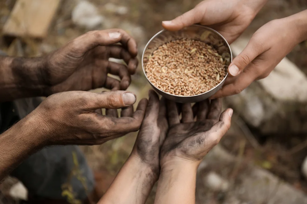 hands sharing food giving help poverty famine 2026 03 30 17 35 51 utc