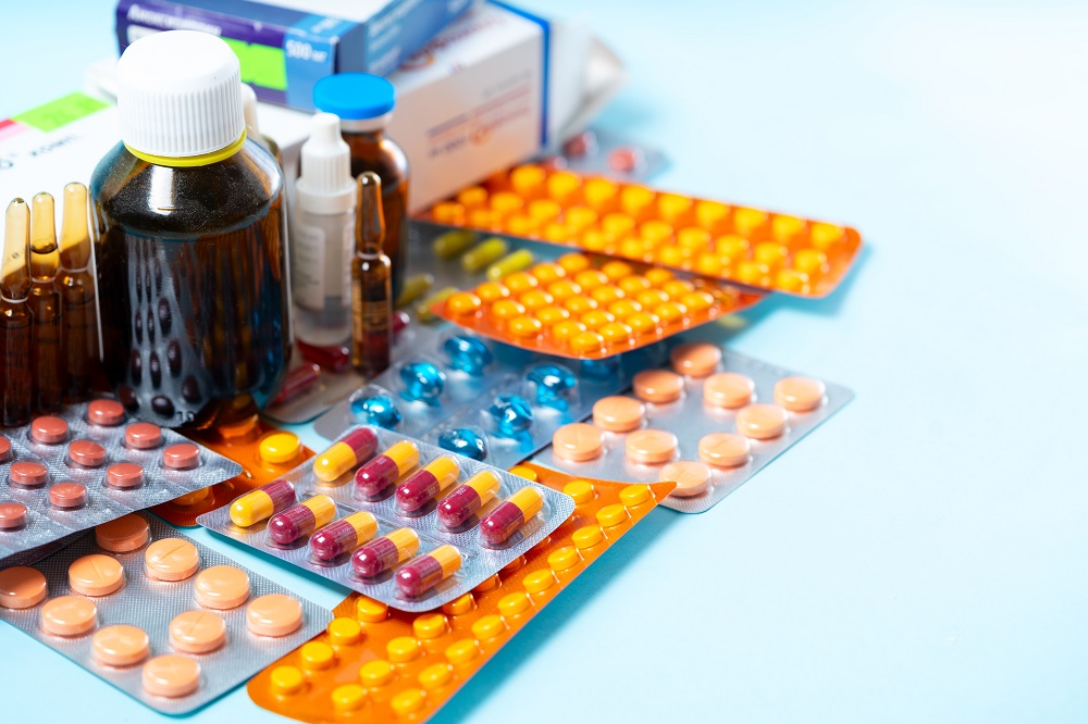 pills and liquid medicine on a light blue surface 2026 03 10 03 19 15 utc
