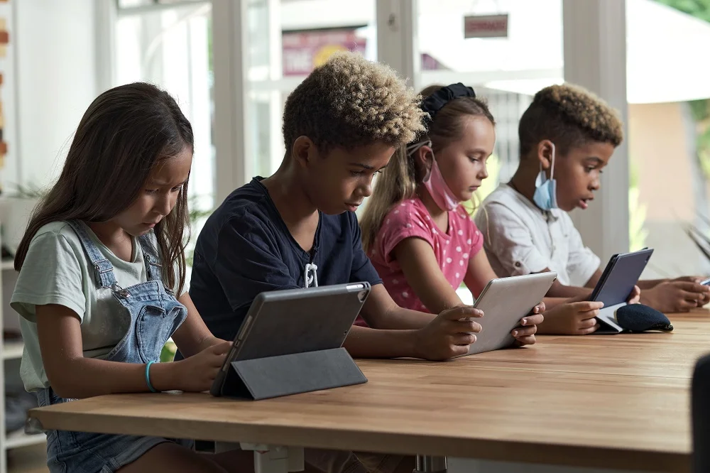 students engaging with tablets at a table 2026 03 18 07 03 41 utc
