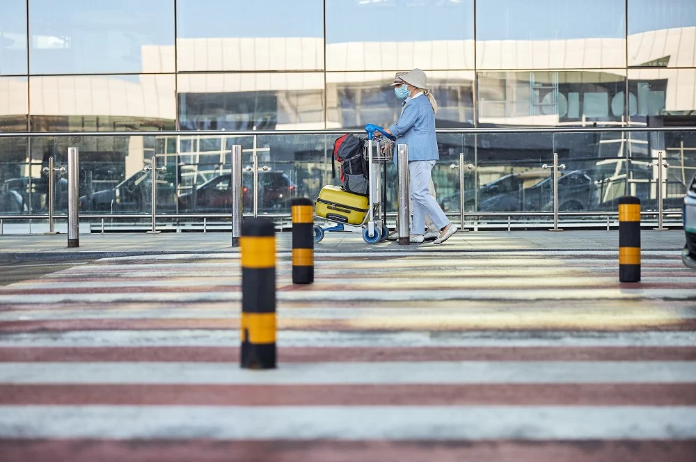 two elderly people passing by the airport terminal 2026 03 10 03 56 34 utc